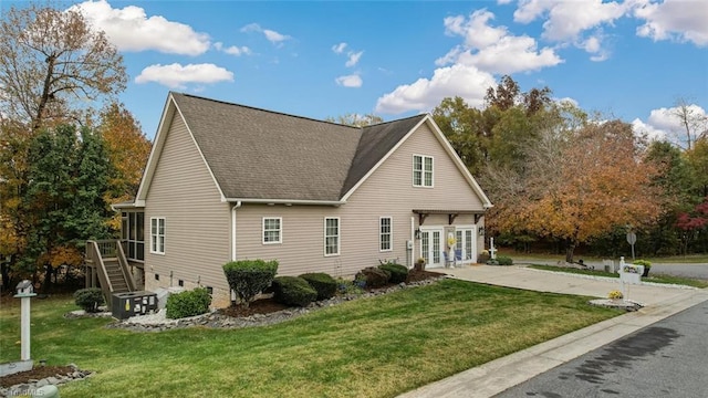 view of side of home with a yard and french doors