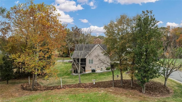 view of side of home featuring a yard