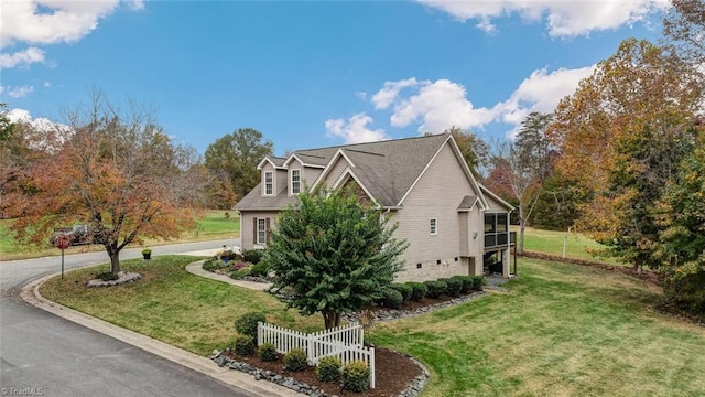 view of side of home with a lawn