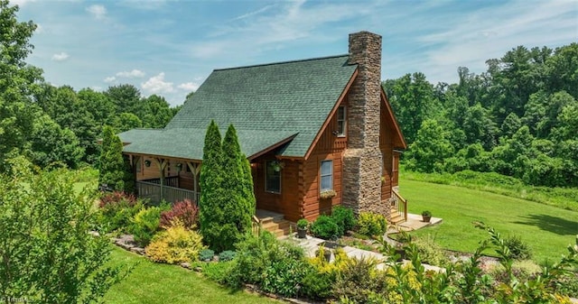 158 Cottontail Ln, North Wilkesboro, NC 28659 - back of house featuring a chimney, a yard, a shingled roof, and log exterior