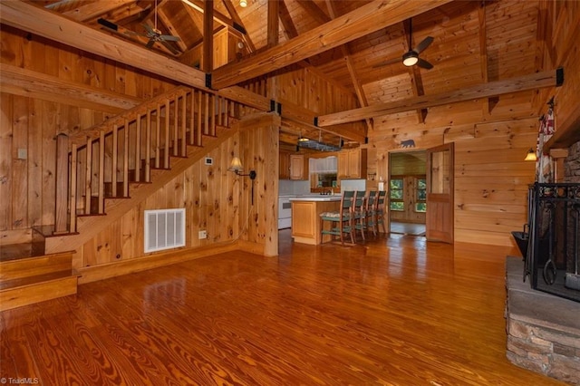 158 Cottontail Ln, North Wilkesboro, NC 28659 - unfurnished living room with a ceiling fan, wooden walls, wood finished floors, stairway, and a wood ceiling with exposed beams