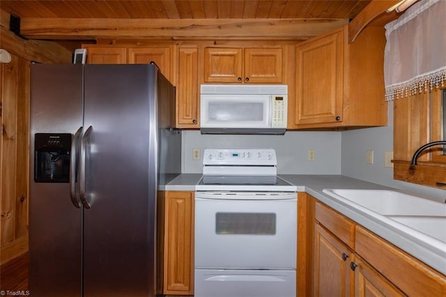 158 Cottontail Ln, North Wilkesboro, NC 28659 - kitchen with white appliances, wood ceiling, brown cabinets, and light countertops