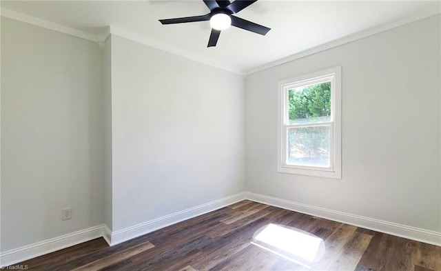 spare room with dark wood-type flooring, crown molding, ceiling fan, and baseboards