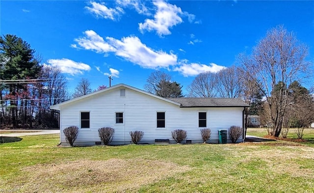 back of property featuring a lawn