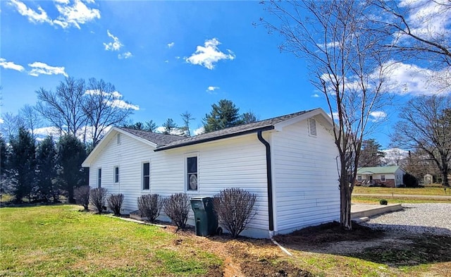 view of side of property with a lawn