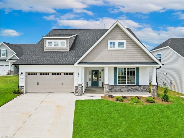 craftsman house with a front lawn, covered porch, and a garage