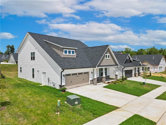 craftsman inspired home with a garage and a front lawn