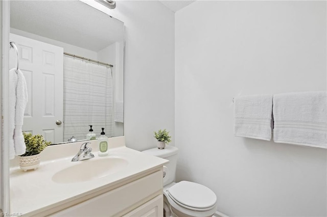 4290 Cedarcroft Ct Unit 2A, Greensboro, NC 27409 - bathroom with toilet, vanity, and a shower with shower curtain