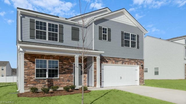 view of front of property featuring a garage and a front yard