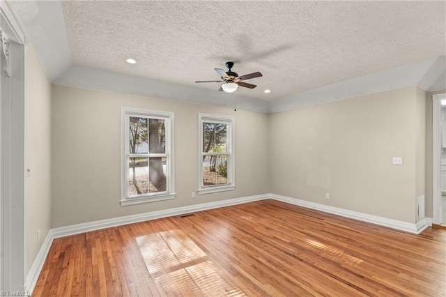 unfurnished room featuring a textured ceiling, ceiling fan, and light hardwood / wood-style flooring