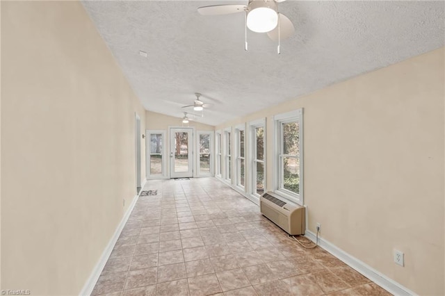 interior space with french doors, a textured ceiling, vaulted ceiling, and light tile floors