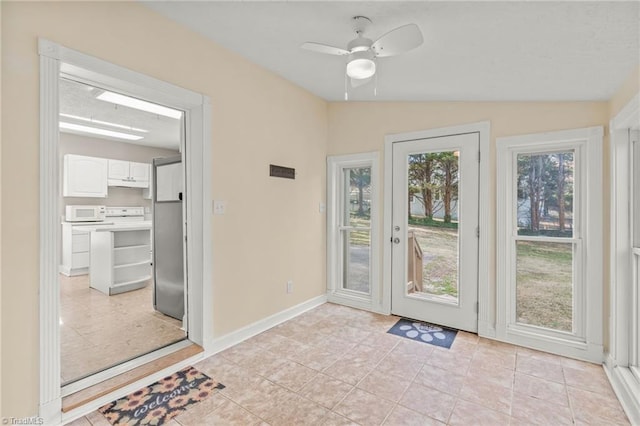 doorway to outside featuring ceiling fan, vaulted ceiling, and light tile floors