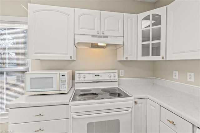 kitchen with white appliances and white cabinetry