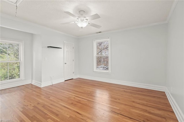 unfurnished room with crown molding, ceiling fan, and light hardwood / wood-style flooring