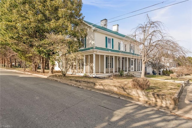 country-style home featuring covered porch