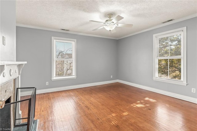 interior space with ceiling fan, crown molding, dark hardwood / wood-style floors, and a textured ceiling