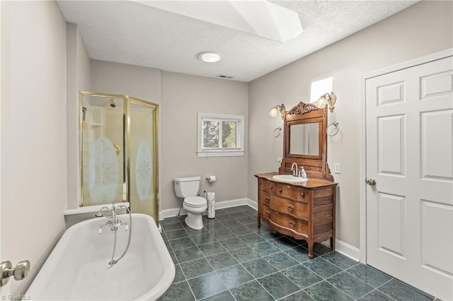 bathroom with a skylight, tile flooring, vanity with extensive cabinet space, and toilet