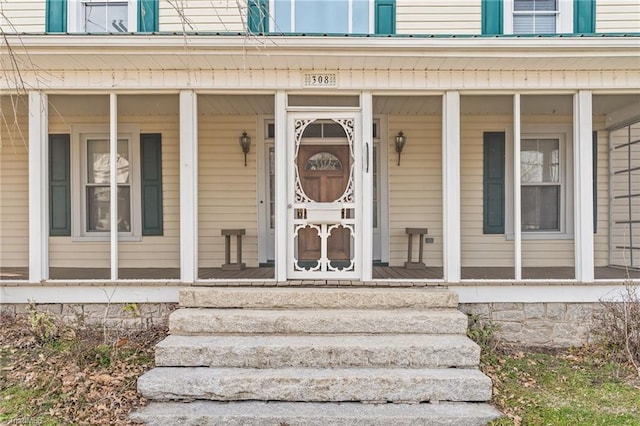 doorway to property featuring a porch