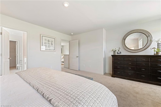 bedroom with baseboards and light colored carpet