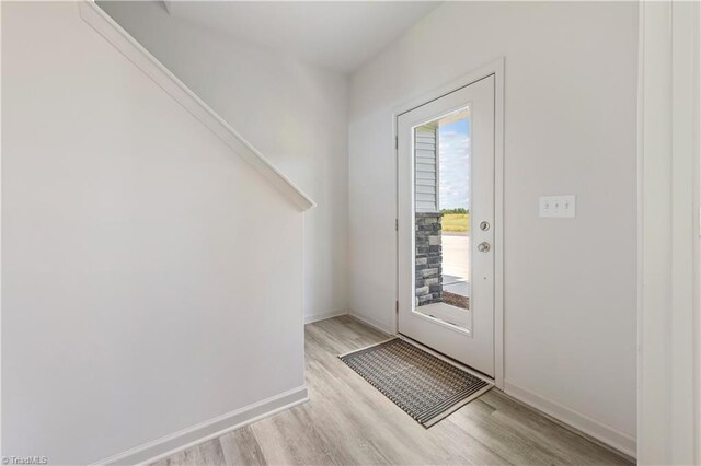 entryway featuring light wood-style flooring and baseboards