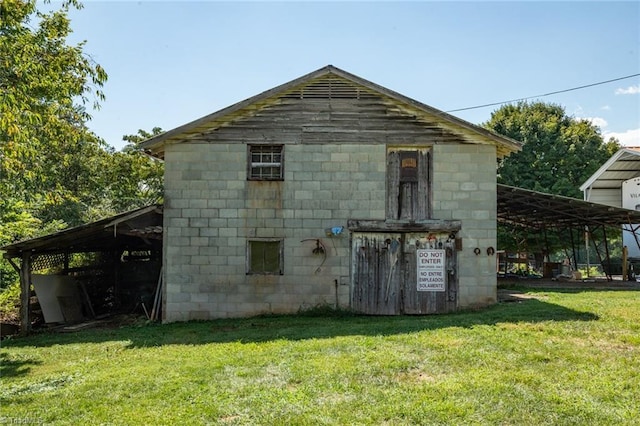 view of home's exterior featuring a carport and a lawn