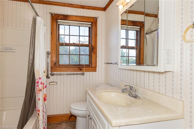 full bathroom with vanity, toilet, a wealth of natural light, and crown molding