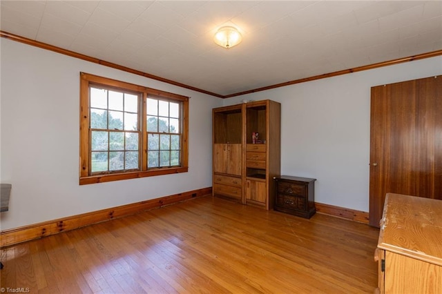 unfurnished bedroom with light hardwood / wood-style floors and ornamental molding