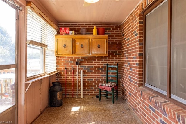 unfurnished sunroom with wood ceiling