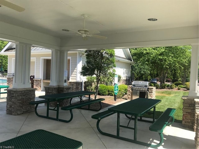 exterior space featuring decorative columns and ceiling fan