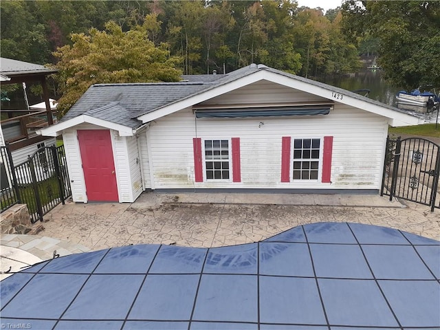 rear view of property with a water view and a patio