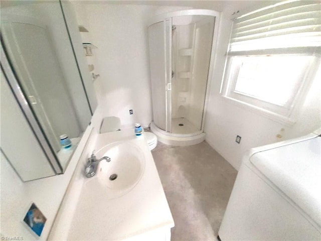 bathroom with a shower with door, vanity, and toilet