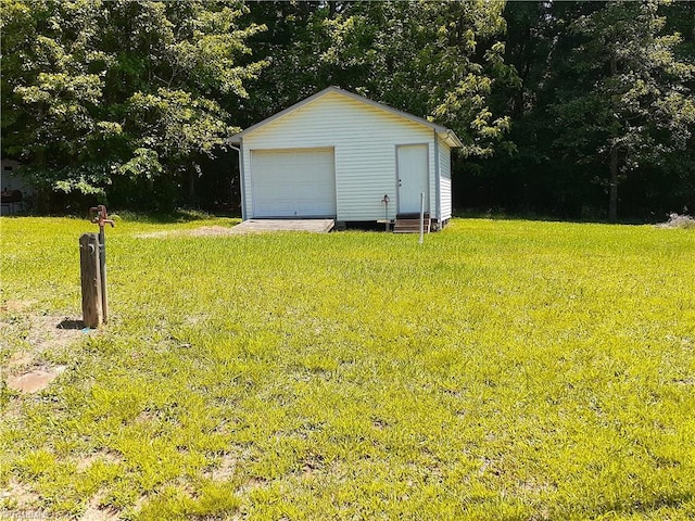 view of yard with a garage and an outdoor structure