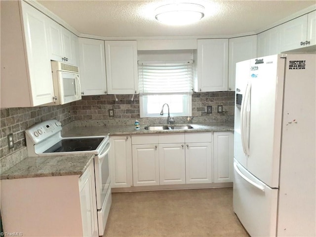 kitchen with white appliances, backsplash, sink, a textured ceiling, and white cabinetry