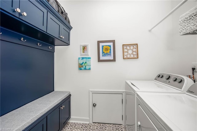 laundry area with washing machine and dryer and cabinets