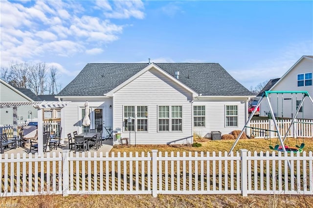 back of property featuring a pergola, a patio area, and a playground