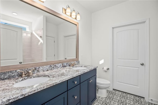 bathroom with vanity, tile patterned floors, and toilet