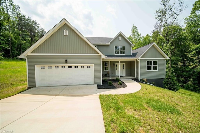 2578 Whipporwill Ct, Rural Hall, NC 27045 - view of front facade with a garage, driveway, a porch, a front lawn, and board and batten siding