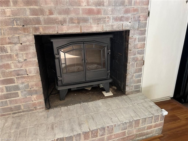 room details featuring hardwood / wood-style floors and a wood stove