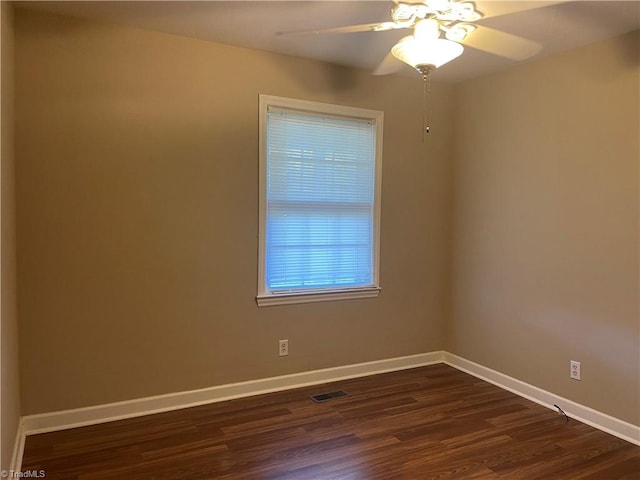 empty room featuring ceiling fan and dark hardwood / wood-style floors