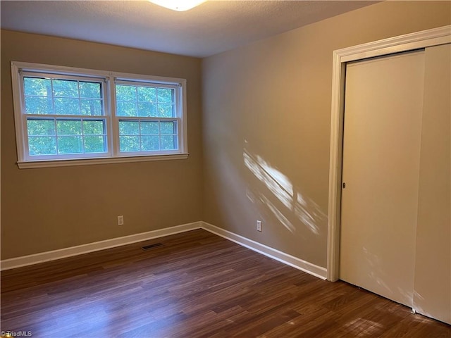 spare room featuring dark hardwood / wood-style flooring