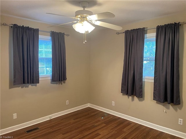 spare room with ceiling fan and dark hardwood / wood-style flooring