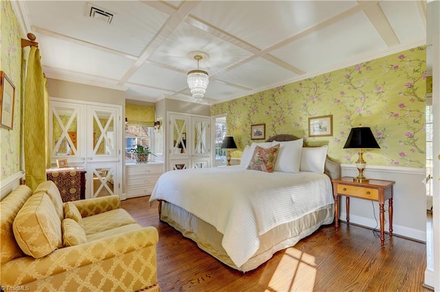 bedroom with wood-type flooring, ceiling fan with notable chandelier, and coffered ceiling