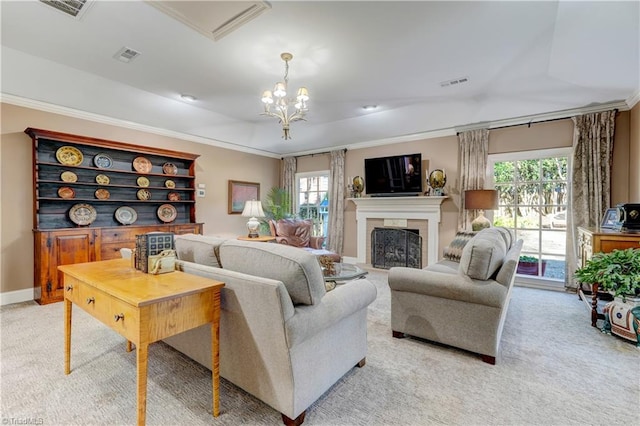 living room featuring plenty of natural light, light colored carpet, a tile fireplace, and a chandelier