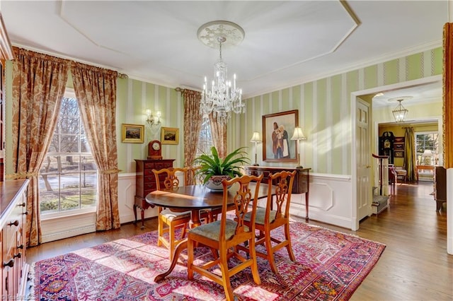 dining room with crown molding, a chandelier, and wood-type flooring