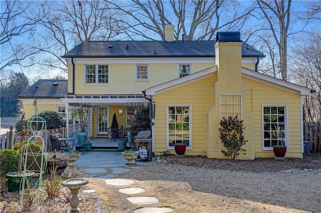 rear view of property featuring cooling unit and a patio area