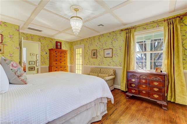 bedroom featuring wood-type flooring and ceiling fan with notable chandelier