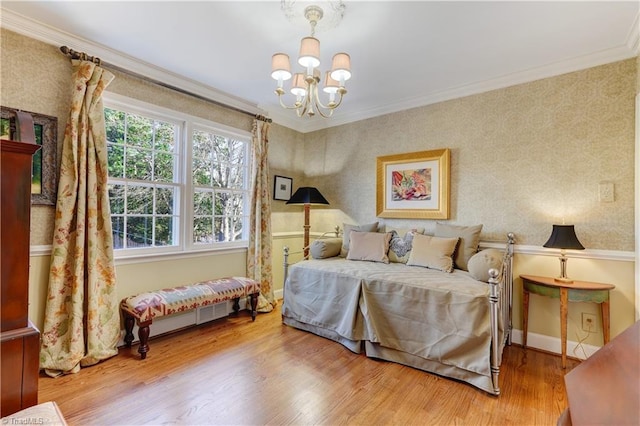 bedroom featuring hardwood / wood-style flooring, crown molding, and a notable chandelier