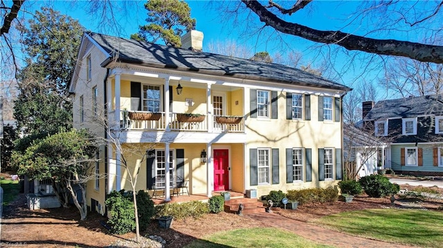 view of front of house featuring a balcony