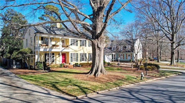 view of front of home featuring a balcony