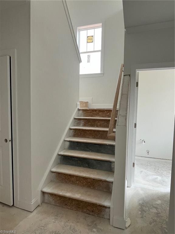 stairway with unfinished concrete floors